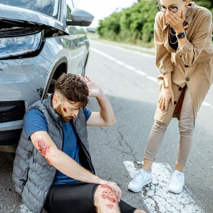 A woman supports and assists a man with a broken leg - The Law Office Of Mark B. Morse LLC